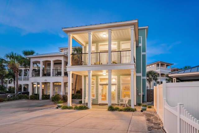 rear view of house with a porch and a balcony