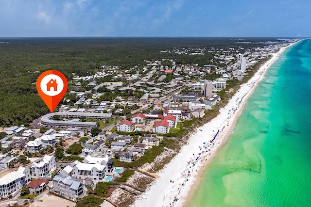 drone / aerial view featuring a beach view and a water view