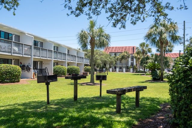 view of property's community with a lawn