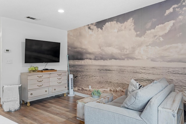 living room with a water view and wood-type flooring