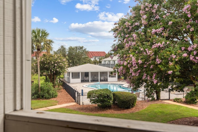 view of swimming pool featuring a sunroom and a patio