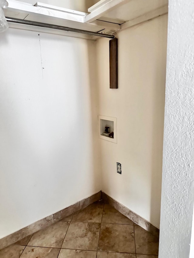 laundry area featuring hookup for a washing machine, tile patterned flooring, laundry area, and baseboards