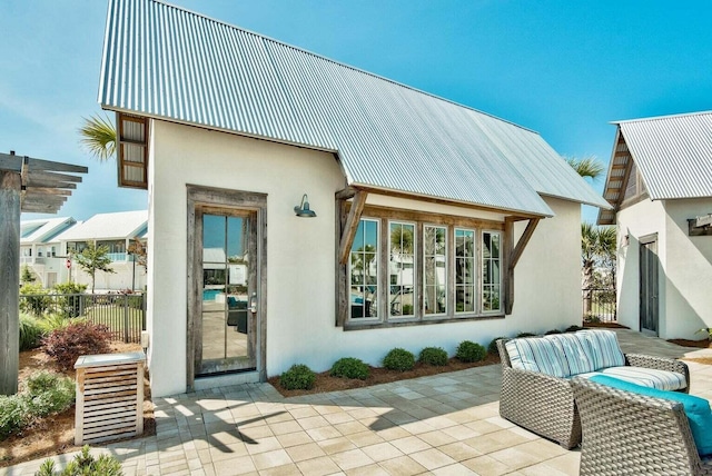 rear view of house featuring outdoor lounge area and a patio