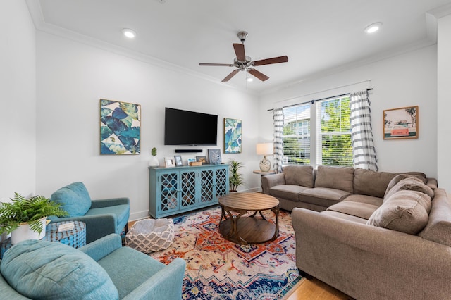 living room featuring ornamental molding, wood-type flooring, and ceiling fan