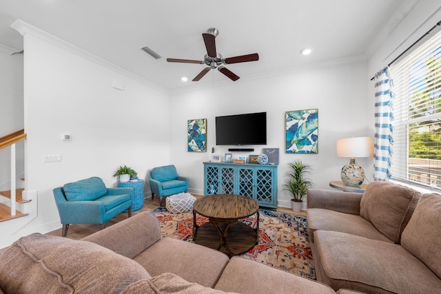 living room with crown molding, wood-type flooring, and ceiling fan