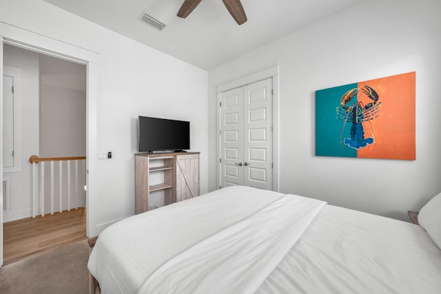 bedroom featuring ceiling fan and light colored carpet