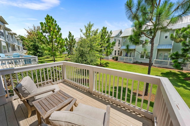 wooden terrace with a lawn