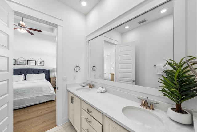 bathroom featuring ceiling fan, vanity, and wood-type flooring