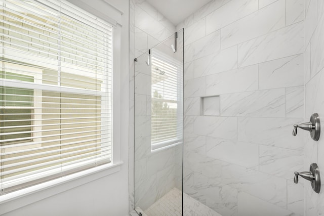 bathroom with a shower with shower door