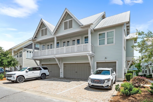 view of front facade featuring a garage and a balcony