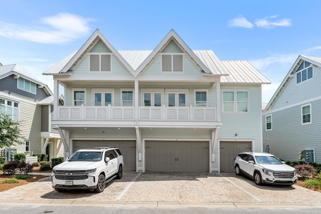 view of front of house featuring a balcony and a garage