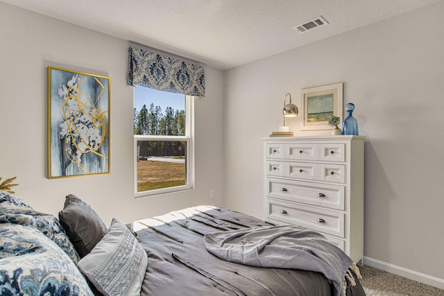 carpeted bedroom featuring a textured ceiling