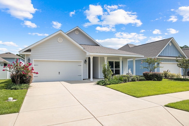 view of front of property featuring a front yard and a garage