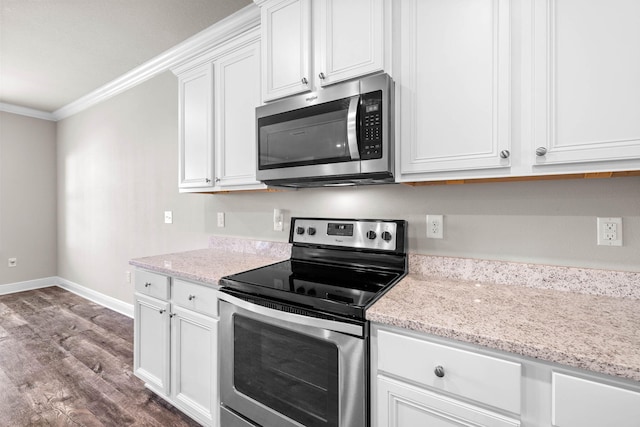 kitchen featuring light stone countertops, white cabinetry, crown molding, and appliances with stainless steel finishes