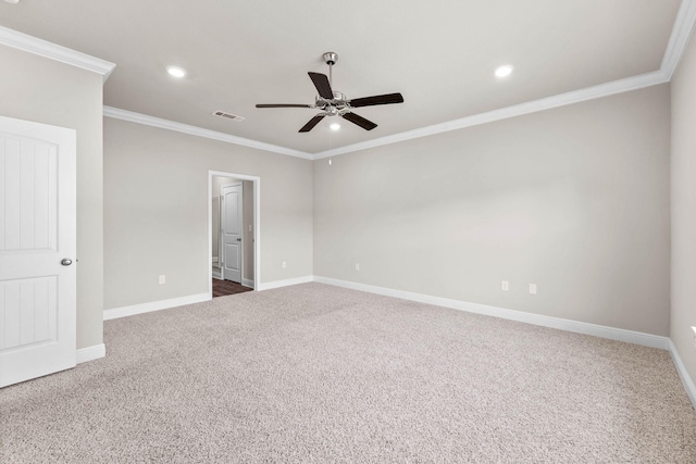 carpeted spare room with ceiling fan and ornamental molding