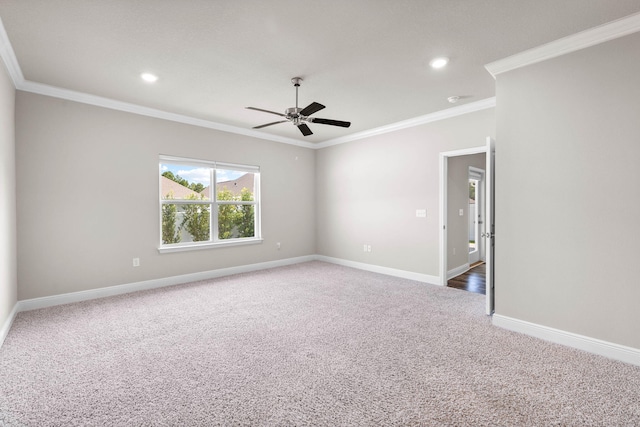 carpeted spare room with ceiling fan and ornamental molding