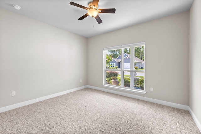 carpeted empty room featuring ceiling fan