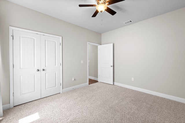 unfurnished bedroom with carpet flooring, a closet, and ceiling fan