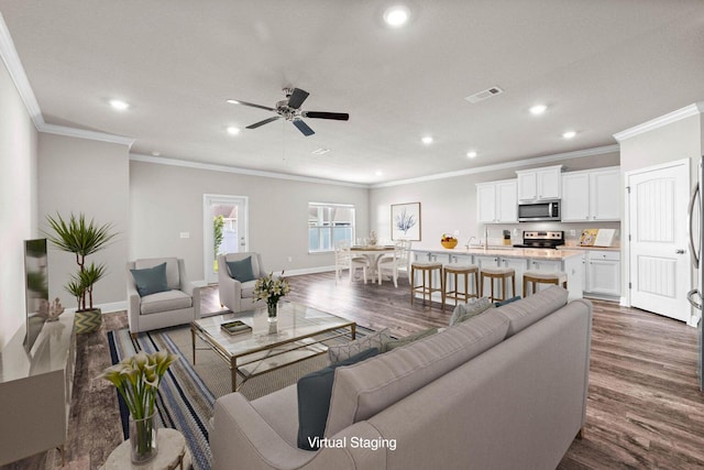 living room featuring dark hardwood / wood-style floors, ceiling fan, crown molding, and sink