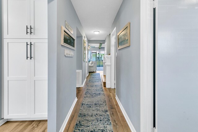 hall with light hardwood / wood-style flooring