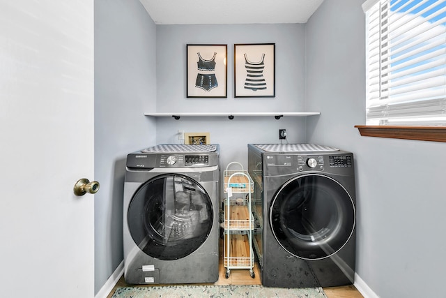 washroom featuring washing machine and clothes dryer