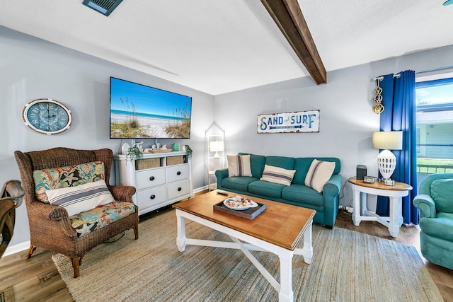 living room featuring hardwood / wood-style flooring and beam ceiling