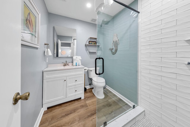 bathroom with vanity, hardwood / wood-style flooring, toilet, and an enclosed shower