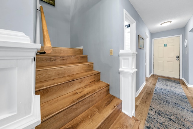 entryway featuring light hardwood / wood-style floors and a textured ceiling