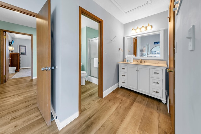 bathroom featuring an enclosed shower, vanity, a textured ceiling, wood-type flooring, and toilet