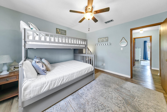 bedroom featuring hardwood / wood-style flooring and ceiling fan