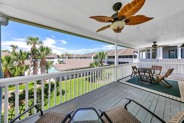 wooden deck featuring ceiling fan and a lawn