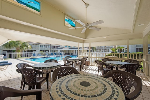 view of swimming pool featuring ceiling fan and a patio area