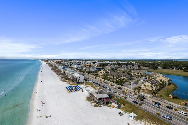 birds eye view of property with a water view and a beach view