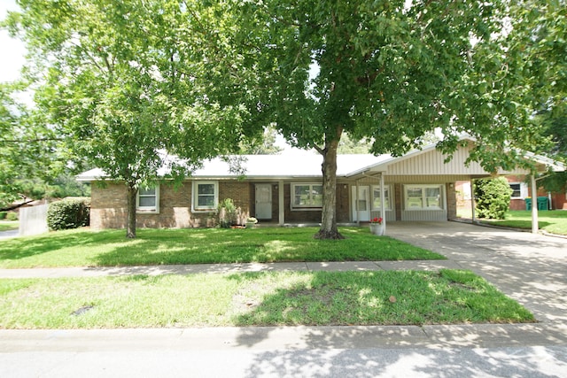 ranch-style home with a carport and a front lawn