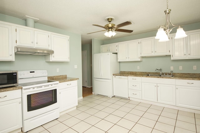 kitchen with white appliances, under cabinet range hood, white cabinetry, pendant lighting, and a sink