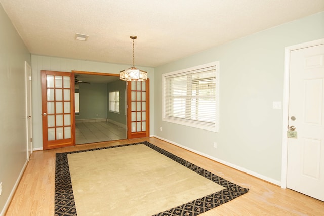 interior space with hardwood / wood-style flooring and a textured ceiling