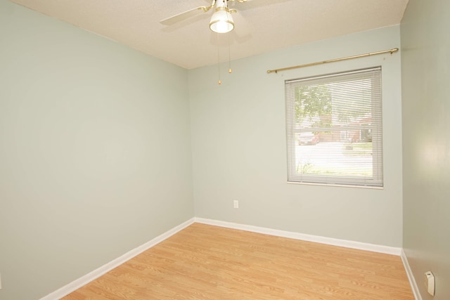 unfurnished room featuring light hardwood / wood-style flooring and ceiling fan