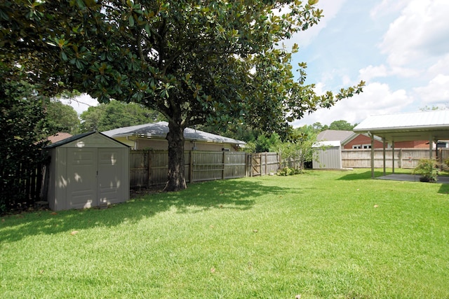 view of yard with a fenced backyard, an outdoor structure, and a storage shed