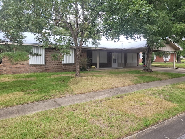 ranch-style house with brick siding, a carport, and a front yard