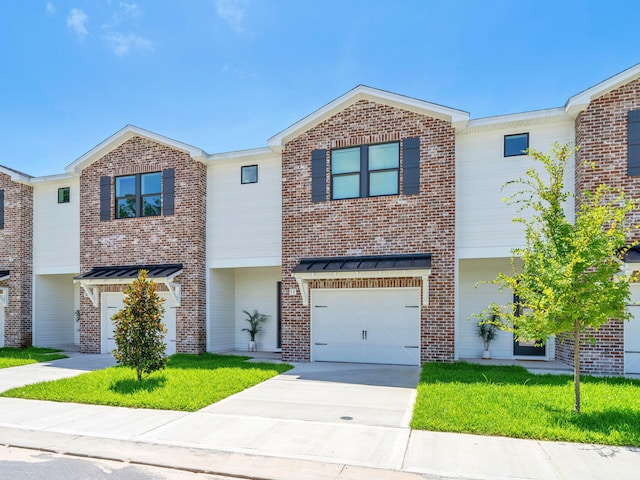 multi unit property featuring a garage and a front lawn