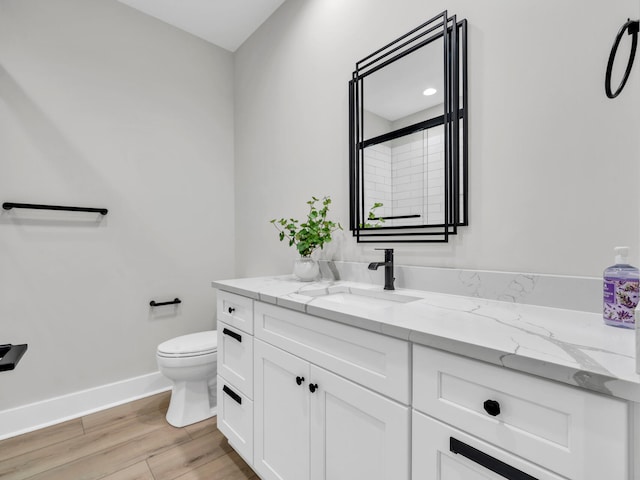 140 Sibert Ave Unit 16, Destin, FL 32541 - full bathroom featuring toilet, vanity, baseboards, and wood finished floors