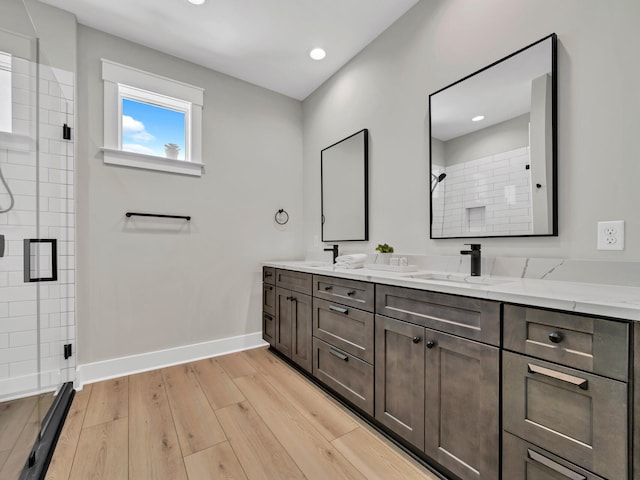 140 Sibert Ave Unit 16, Destin, FL 32541 - full bathroom with double vanity, a stall shower, baseboards, wood finished floors, and recessed lighting