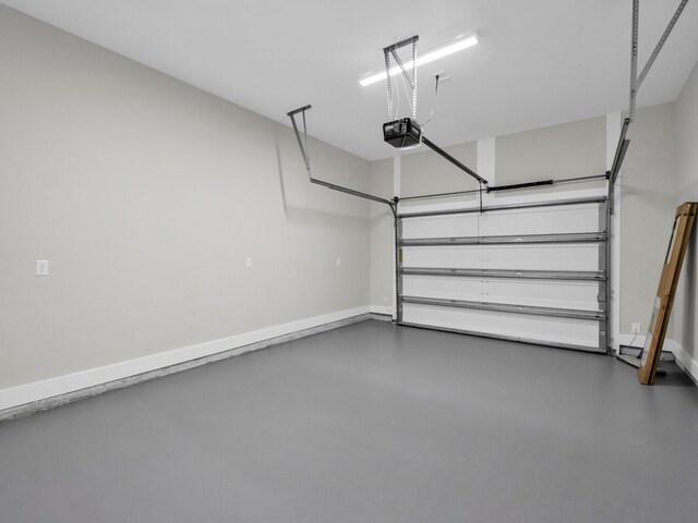 140 Sibert Ave Unit 16, Destin, FL 32541 - garage with a garage door opener and baseboards
