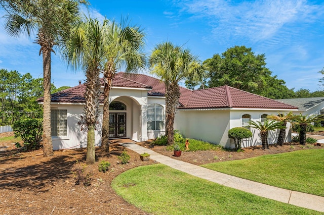 mediterranean / spanish-style house featuring a front yard