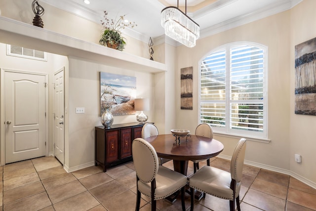 tiled dining space with a wealth of natural light, a notable chandelier, and ornamental molding