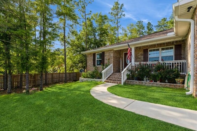 view of front facade featuring covered porch and a front yard