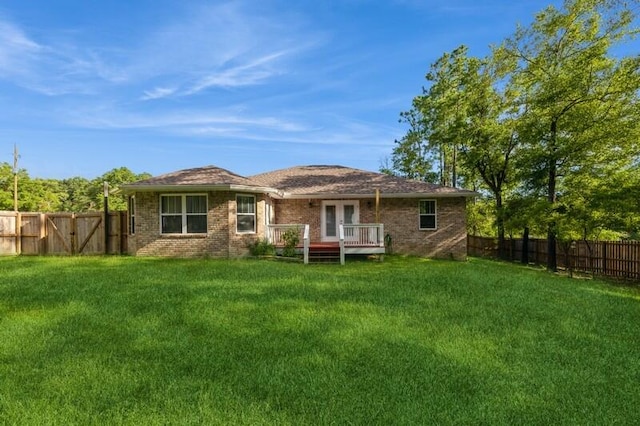 rear view of house featuring a yard