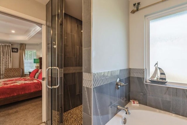 bathroom featuring crown molding, a bath, and a tray ceiling