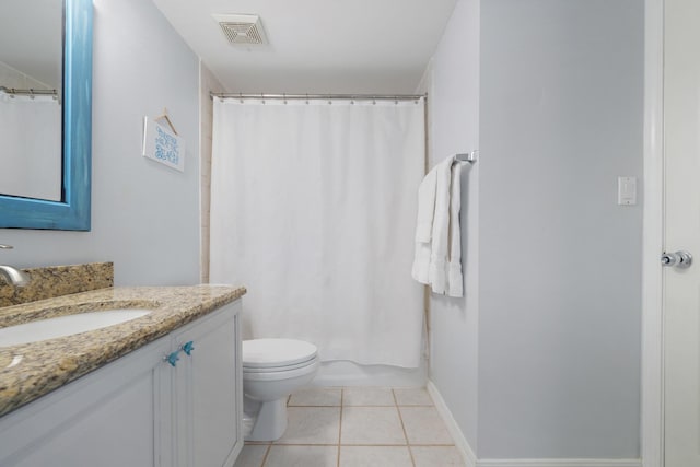 bathroom featuring toilet, vanity, and tile patterned floors