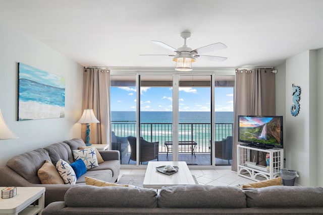 living room with floor to ceiling windows, ceiling fan, plenty of natural light, and light tile patterned flooring